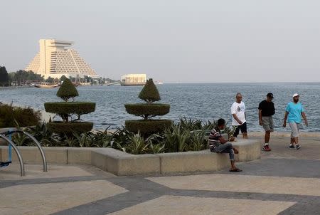 Men walk at the Doha Corniche, Qatar August 30, 2016. REUTERS/Naseem Zeitoon