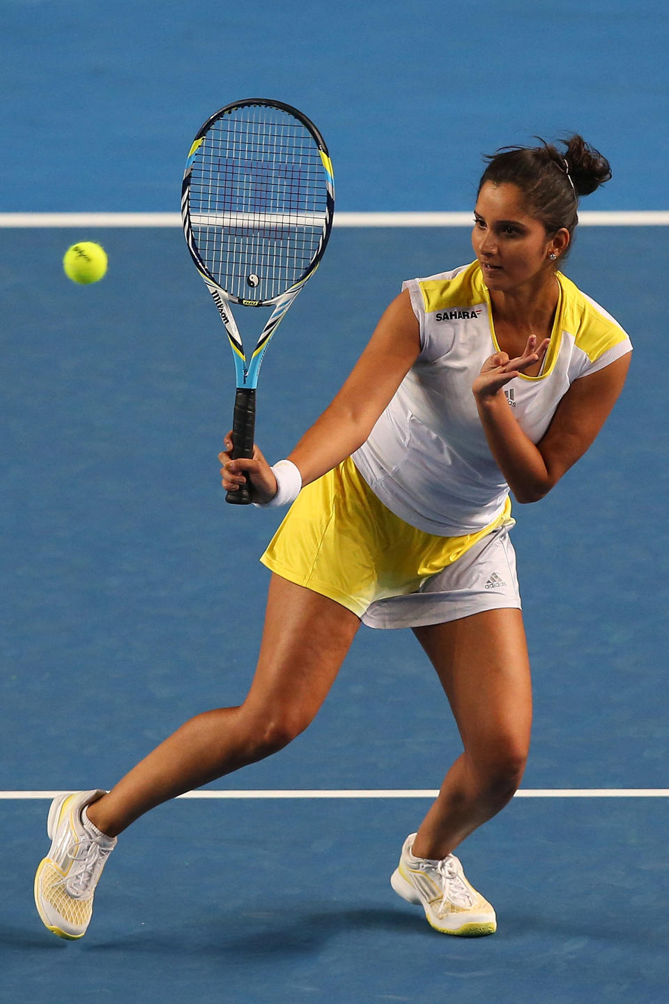 Sania Mirza of India plays a forehand in her mixed doubles match partnered with Bob Bryan of USA against Samantha Stosur and Luke Saville of Australia during day five of the 2013 Australian Open at Melbourne Park on January 18, 2013 in Melbourne, Australia. 