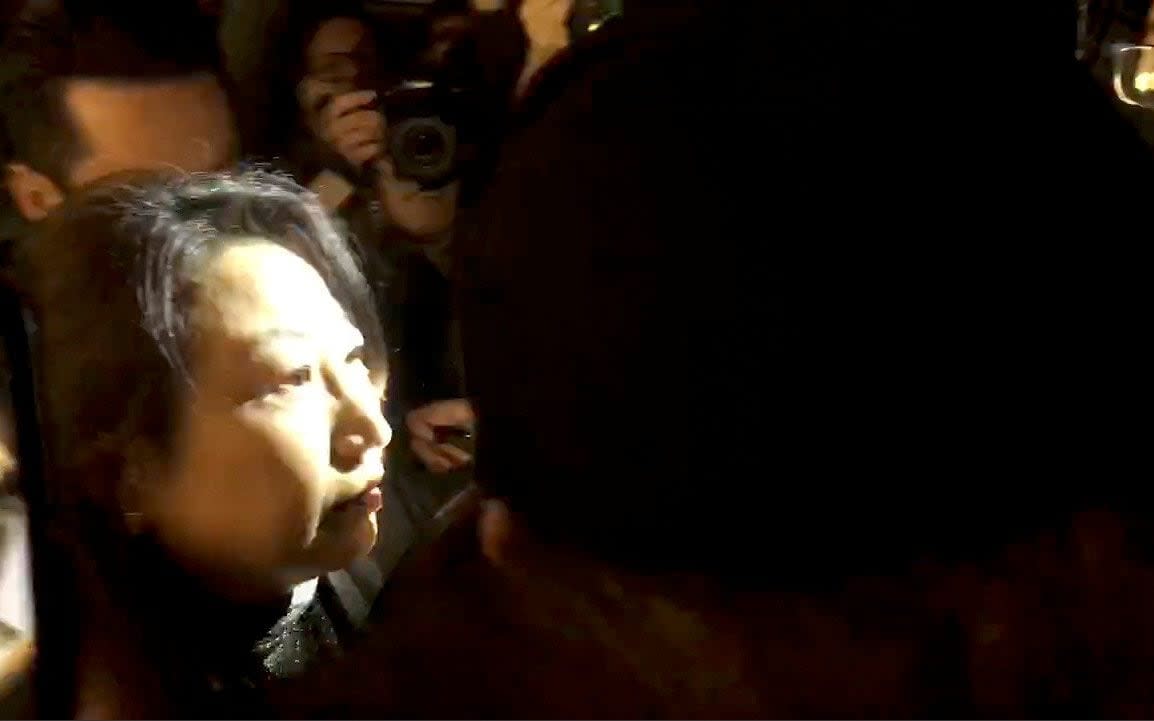 Hong Kong Justice Secretary Teresa Cheng walks as protesters surround her in London - CHLOE LEUNG VIA REUTERS