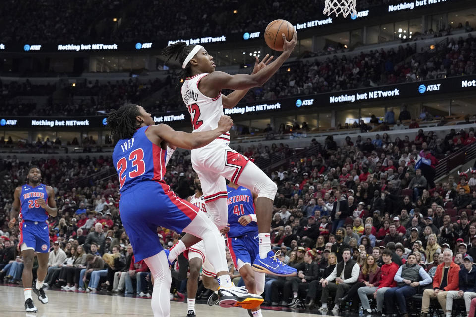 Chicago Bulls guard Ayo Dosunmu, right, drives to the basket past Detroit Pistons guard Jaden Ivey during the first half of an NBA basketball game in Chicago, Friday, Dec. 30, 2022. (AP Photo/Nam Y. Huh)