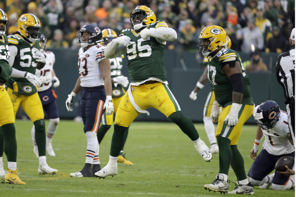 Green Bay Packers defensive tackle Devonte Wyatt (95) celebrates after sacking Chicago Bears quarterback Justin Fields (1) during the first half of an NFL football game Sunday, Jan. 7, 2024, in Green Bay, Wis. (AP Photo/Mike Roemer)