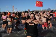 <p>Participants rush in the water during a polar bear plunge at the beach in Coney Island, Brooklyn on Jan. 1, 2018. New Yorkers took part in new year’s day swim with temperature standing at -7 degrees Celsius. (Photo: Atilgan Ozdil/Anadolu Agency/Getty Images) </p>