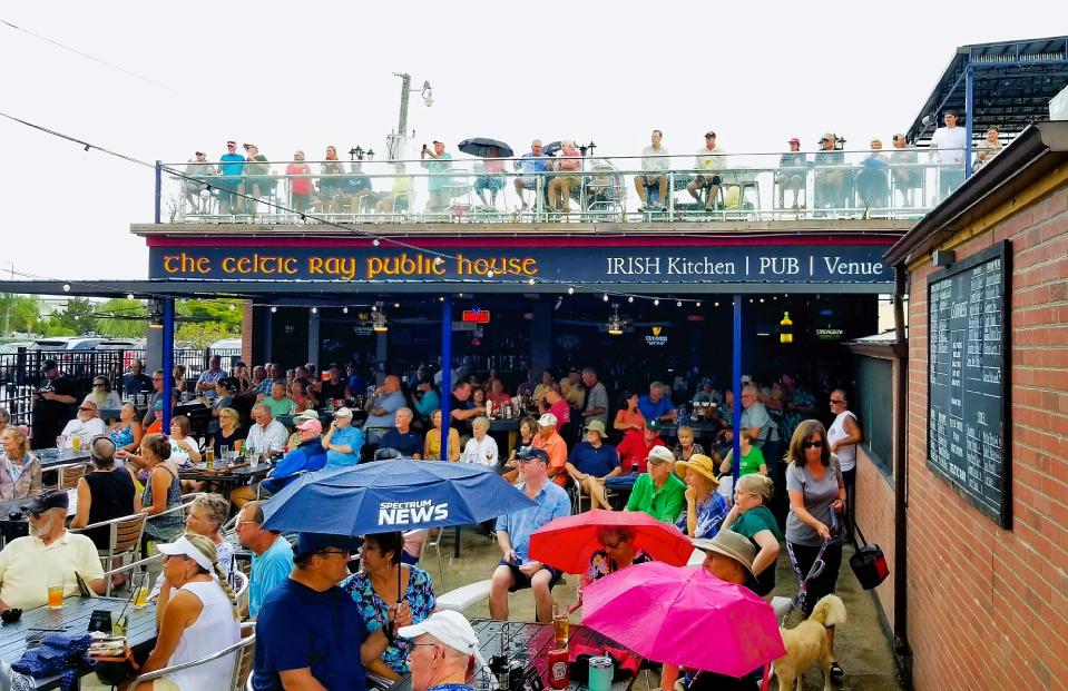 A large crowd stays through the rain during The Champ Jaxon Band’s performance at The Celtic Ray Public House in Punta Gorda on April 30, 2022.