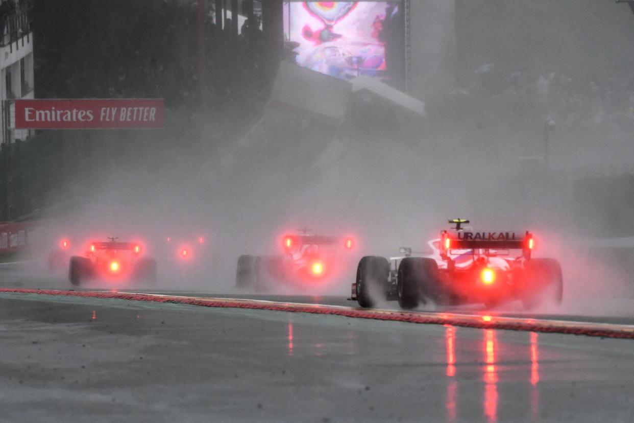 F1 dirvers drive behind the safety car during preliminary laps as the race is postponed over rainy weather during the Formula One Belgian Grand Prix at the Spa-Francorchamps circuit in Spa on August 29, 2021. (Photo by JOHN THYS / AFP) (Photo by JOHN THYS/AFP via Getty Images)