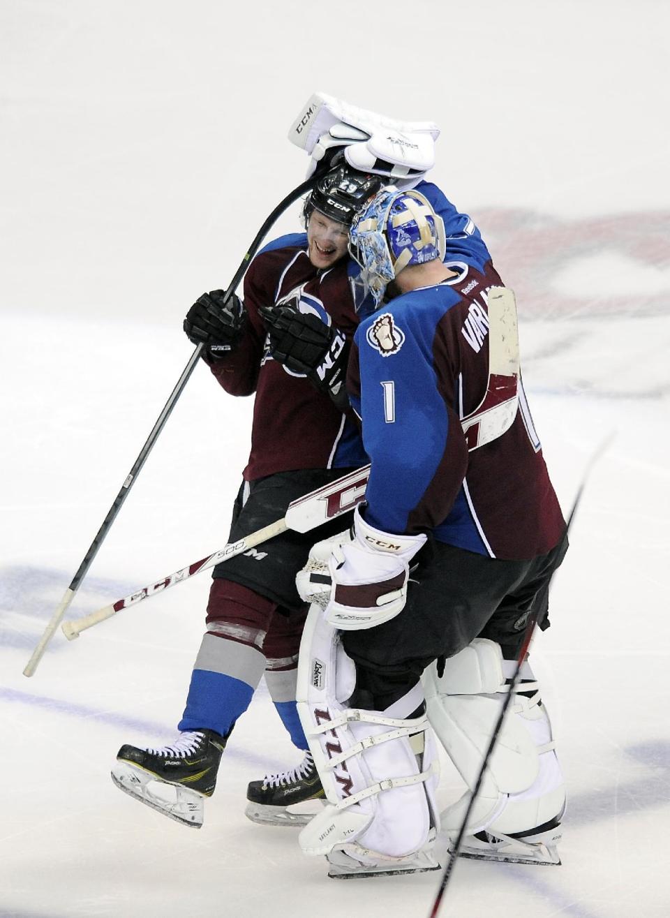 Colorado Avalanche goalie Semyon Varlamov, right, of Russia, congratulates Avalanche center Nathan MacKinnon, left, after MacKinnon scored the game-winning goal in overtime in Game 5 of an NHL hockey first-round playoff series against the Minnesota Wild on Saturday, April 26, 2014, in Denver. The Avalanche won 4-3. (AP Photo/Chris Schneider)