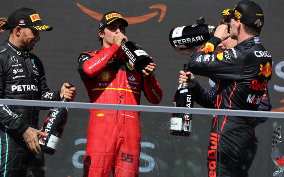 Formula One F1 - Canadian Grand Prix - Circuit Gilles Villeneuve, Montreal, Canada - June 19, 2022 Red Bull's Max Verstappen celebrates on the podium after winning the race with second placed Ferrari's Carlos Sainz Jr. and third placed Mercedes' Lewis Hamilton - Chris Helgren/REUTERS