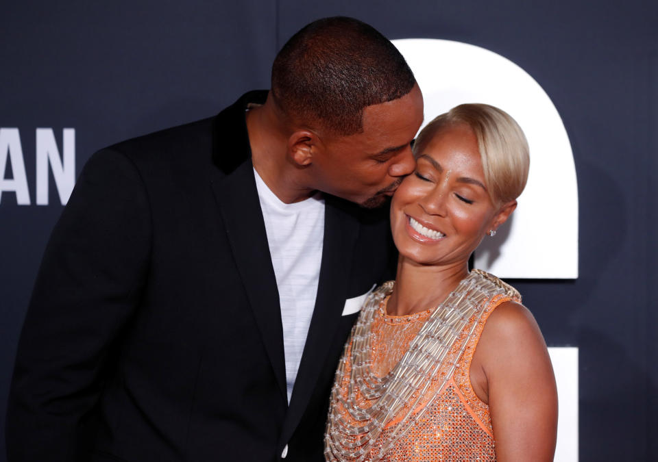 Cast member Will Smith kisses his wife actress Jada Pinkett Smith at the premiere of 