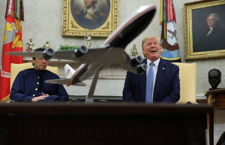 U.S. President Trump talks with reporters while meeting with Pakistan’s Prime Minister Khan in the Oval Office of the White House in Washington