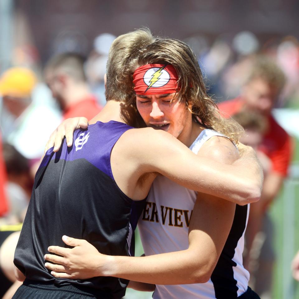 River View's Sam Adams gets a hug from Martins Ferry's Francis Toohey after finishing the 800 on Saturday at the Division II state track and field meet at Jesse Owens Memorial Stadium in Columbus. Adams was eighth overall to earn All-Ohio honors.