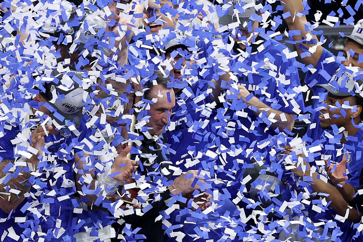 SAN FRANCISCO, CALIFORNIA - MARCH 26: The Duke Blue Devils players dump confetti onto head coach Mike Krzyzewski after defeating the Arkansas Razorbacks 78-69 in the NCAA Men's Basketball Tournament Elite 8 Round at Chase Center on March 26, 2022 in San Francisco, California. (Photo by Ezra Shaw/Getty Images)