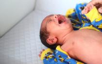 George Khnaisser, whose mother was in labour at the moment of the Beirut port blast, lies on a changing table at the family home in Jal el-Dib