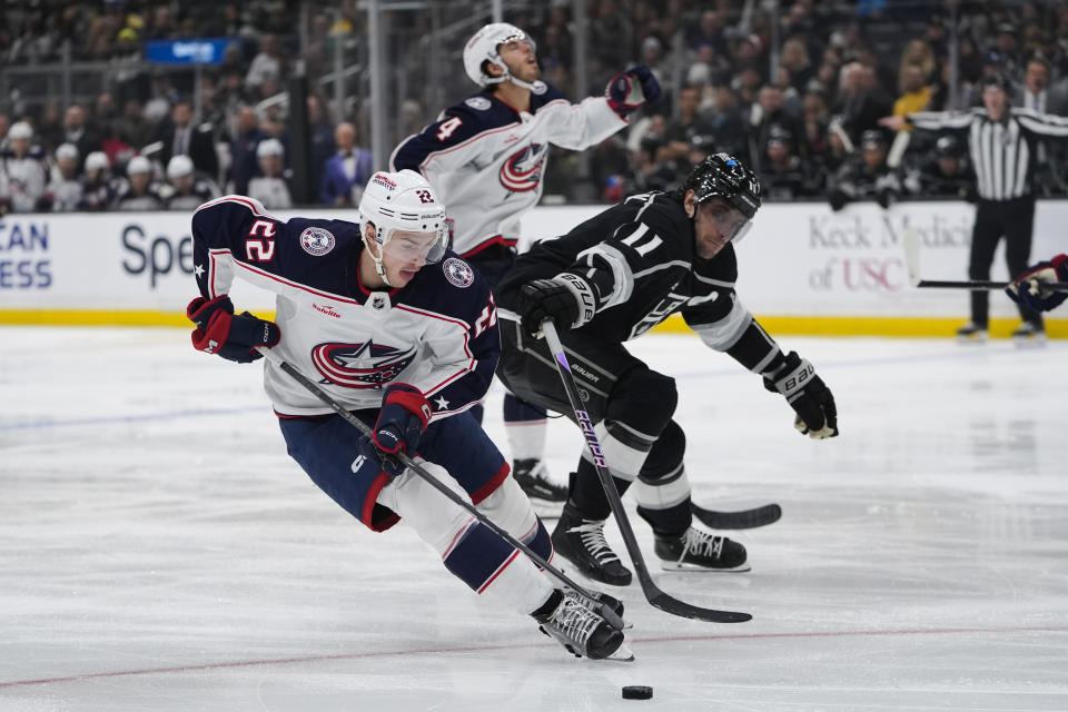 Columbus Blue Jackets defenseman Jake Bean, left, controls the puck against Los Angeles Kings center Anze Kopitar during the second period of an NHL hockey game Tuesday, Feb. 20, 2024, in Los Angeles. (AP Photo/Ryan Sun)