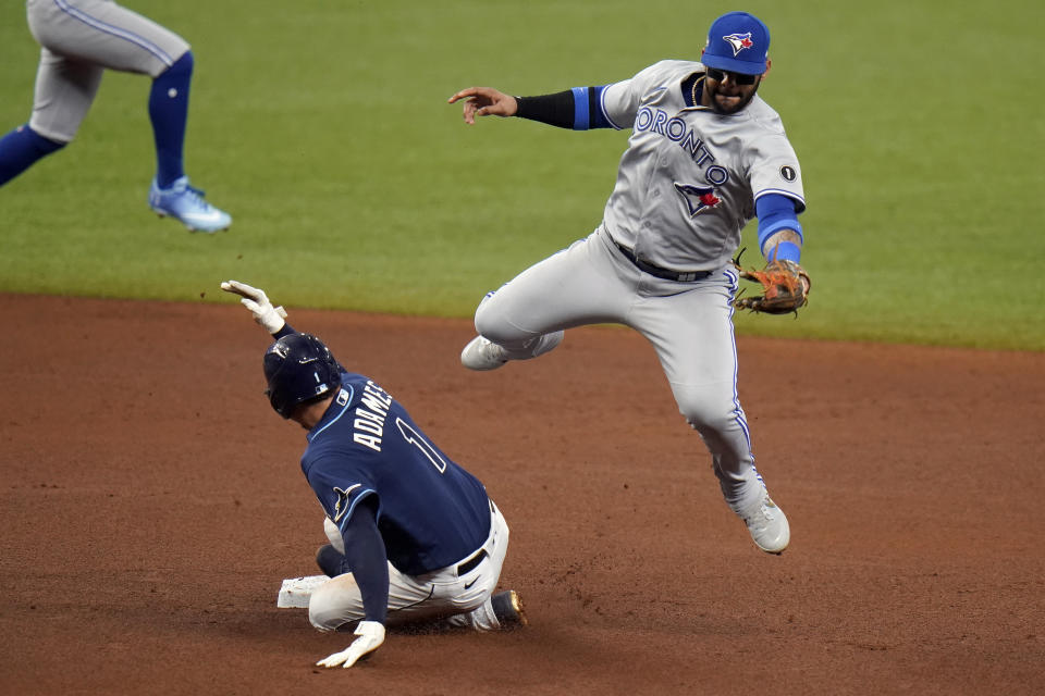 Tampa Bay Rays' Willy Adames (1) steals second base as Toronto Blue Jays' Jonathan Villar fields a high throw during the fourth inning of Game 1 of a wild card series playoff baseball game Tuesday, Sept. 29, 2020, in St. Petersburg, Fla. (AP Photo/Chris O'Meara)
