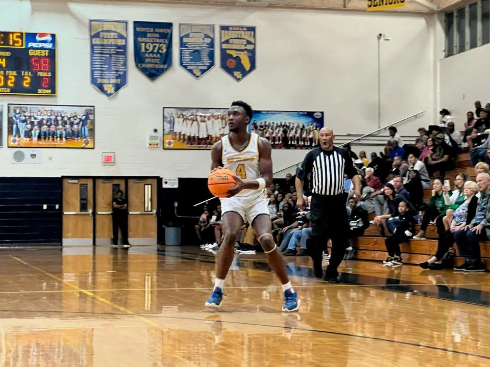 Winter Haven's Isaac Celiscar readies to unleash a 3. He scored 22 in the district title game vs. Durant on Feb. 10, 2024 at Winter Haven High School. WH also earned another district title.