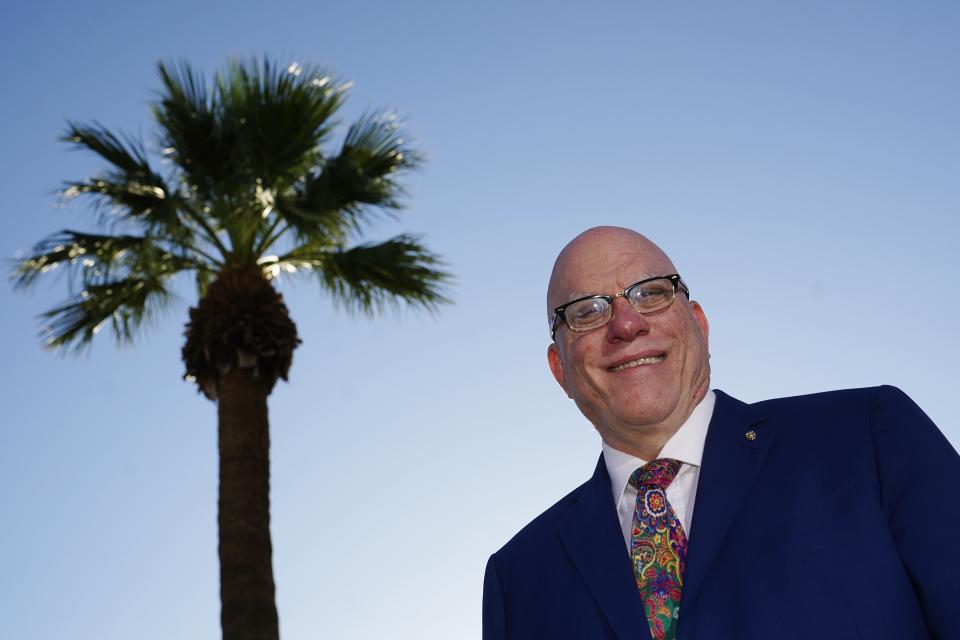 R. Glenn Williamson, Canada's Arizona honorary consul and founder and CEO of the Canada Arizona Business Council, soaks up the morning sun at the Arizona Biltmore resort Wednesday, Oct. 27, 2021, in Phoenix. Williamson says he's looking forward to the return of Canadian snowbirds to the state now that vaccinated people from other countries can enter the U.S. by land starting Nov. 8. (AP Photo/Ross D. Franklin)