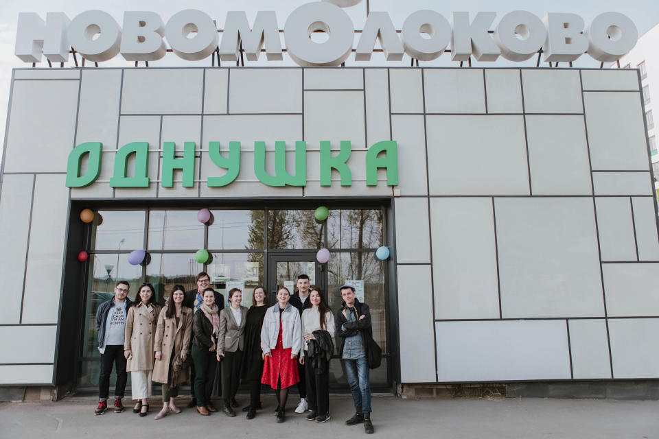 In this handout photo taken in Wednesday, May 1, 2019, a group of enthusiasts of a specially-constructed studio "odnushka," an apartment in Novo-Molokovo pose for a photo in Moscow, Russia. A residential complex called Novo-Molokovo, just outside Moscow and still under construction, houses the newest generation of Muscovites. A studio apartment here costs $95,500. Moscow’s suburbs are the focus of a major international art exhibition that has just opened in the Russian capital. The exhibit uses contemporary art to explore the many hidden facets of life beyond the Russian capital’s nucleus. Austrian cultural attache says the ‘real’ Moscow where most of the city’s 12.6 million people live, is outside the center. (Diana Validova via AP)