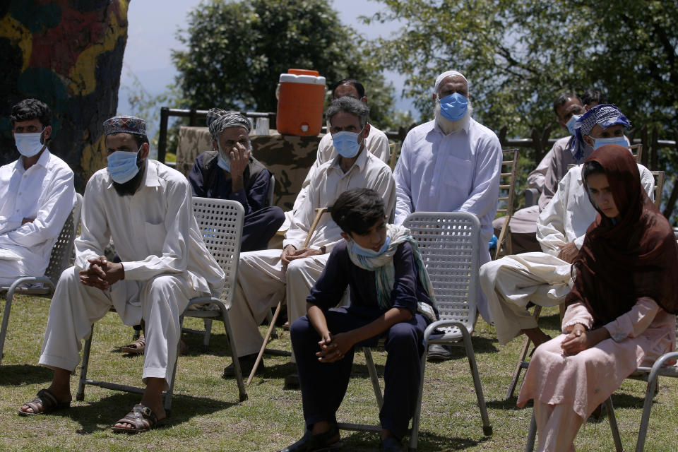 Kashmiri villagers wait to interact with journalists in Chiri Kot sector near the Line of Control, that divides Kashmir between Pakistan and India, Wednesday, July 22, 2020. Villagers living along a highly militarized frontier in the disputed region of Kashmir have accused India of "intentionally targeting" civilians, but they are vowing that they would never leave their areas. Villagers say the fear of death is no longer present in their hearts after spending so many years in a state of shock and uncertainty. (AP Photo/Anjum Naveed)