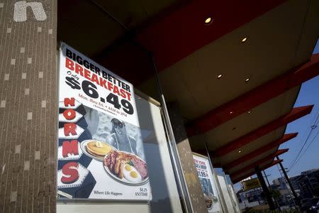 Signage is displayed outside Norms Diner on La Cienega Boulevard in Los Angeles, California May 20, 2015. REUTERS/Patrick T. Fallon