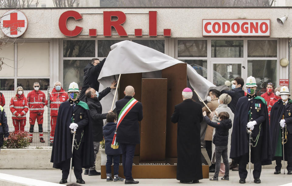 Authorities unveil a memorial for COVID deaths, in Codogno, northern Italy, Sunday, Feb. 21, 2021. The first case of locally spread COVID-19 in Europe was found in the small town of Codogno, Italy one year ago on February 21st, 2020. The next day the area became a red zone, locked down and cutoff from the rest of Italy with soldiers standing at roadblocks keeping anyone from entering of leaving. (AP Photo/Luca Bruno)