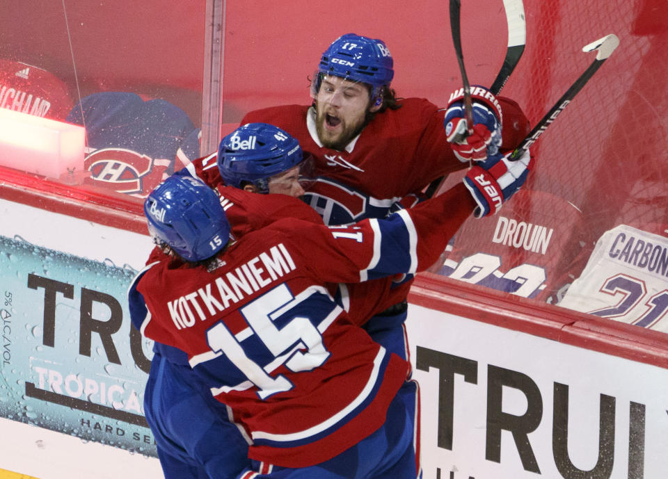 Montreal Canadiens' Josh Anderson celebrates with Paul Byron and Jesperi Kotkaniemi after scoring in overtime against the Vegas Golden Knights in Game 3 of an NHL hockey semifinal series, Friday, June 18, 2021, in Montreal. (Paul Chiasson/The Canadian Press via AP)