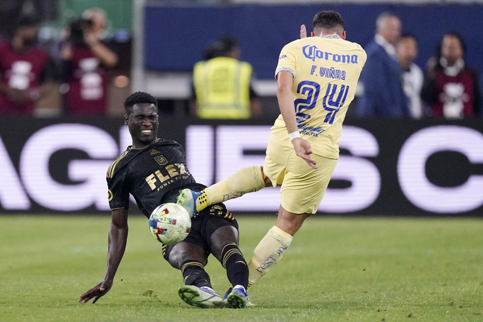 Los Angeles FC defender Mamadou Fall, left, tackles Club America forward Federico Vinas during the first half of a Leagues Cup soccer match Wednesday, Aug. 3, 2022, in Inglewood, Calif. Fall received a yellow card on the play. (AP Photo/Mark J. Terrill)
