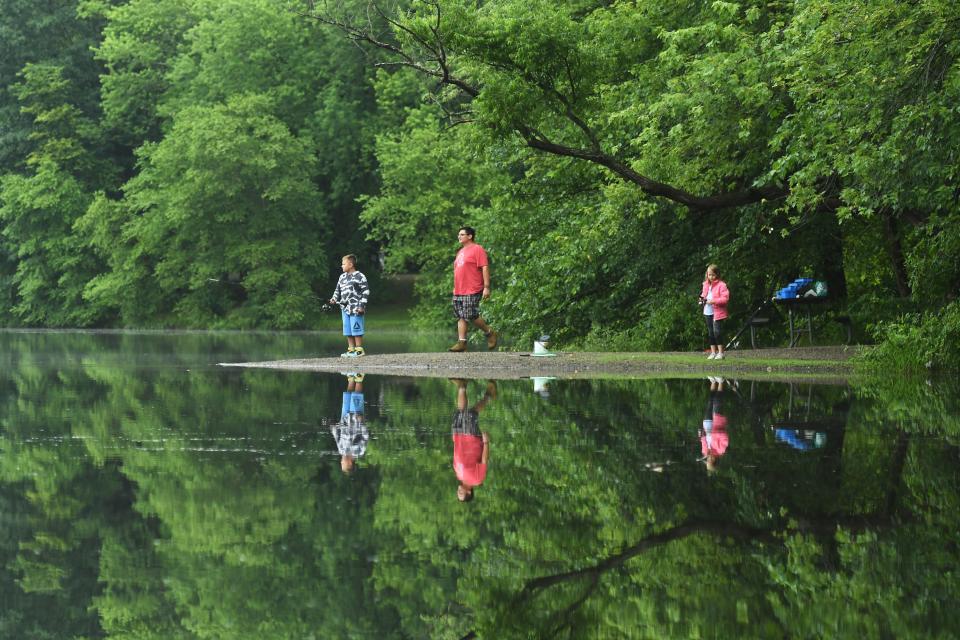 Dan Padilla, of Suffern, N.Y., helps is son, Lewis, 8, and daughter, Riley, 7, fish at Scarlet Oak Pond at Ramapo Valley County Reservation in Mahwah, N.J. on Tuesday July 13, 2021. 