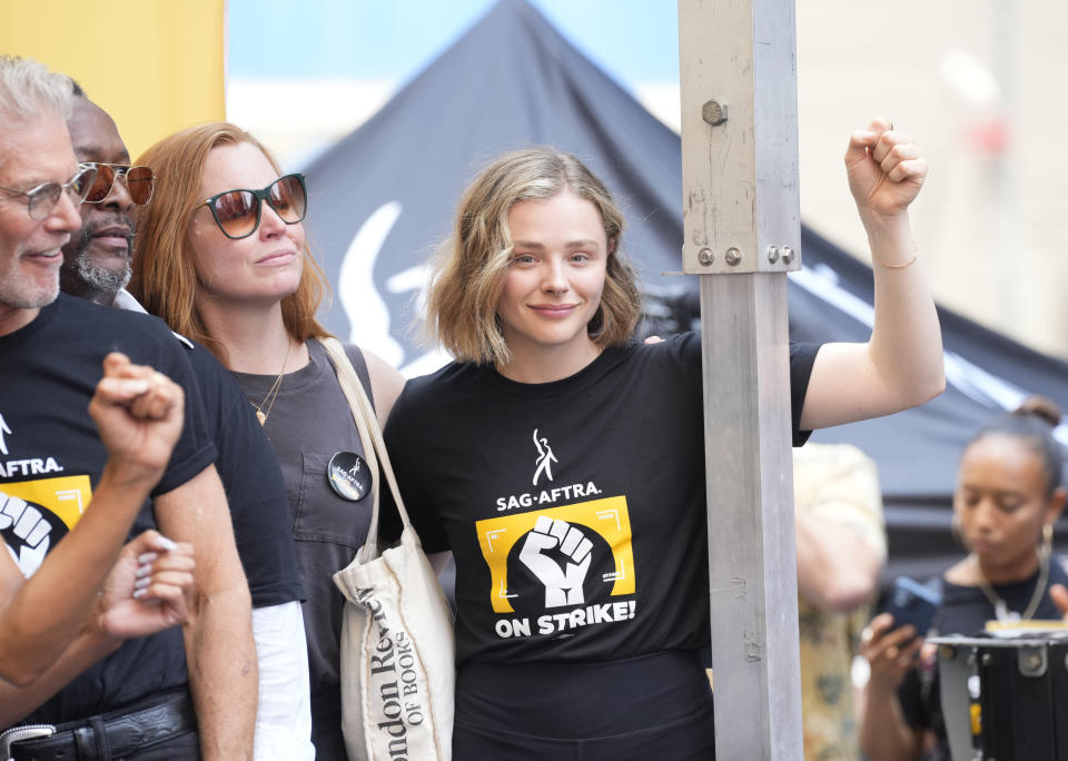 Actors Stephen Lang, from left, Wendell Pierce, Lauren Ambrose, and Chloe Grace Moretz attend the SAG-AFTRA "Rock the City for a Fair Contract" rally in Times Square on Tuesday, July 25, 2023, in New York. The actors strike comes more than two months after screenwriters began striking in their bid to get better pay and working conditions. (Photo by Charles Sykes/Invision/AP)