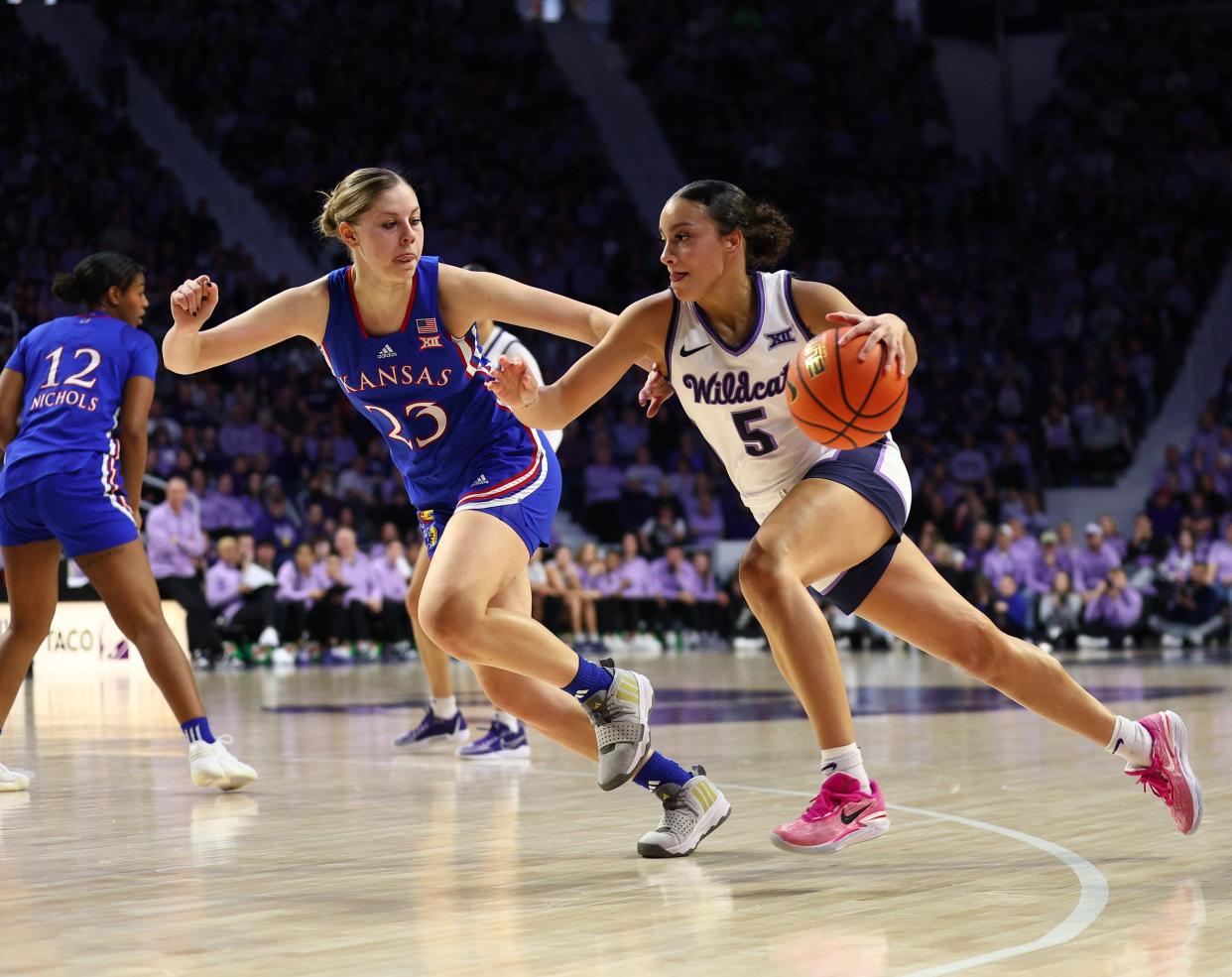 Kansas State guard Brylee Glenn (5) dribbles against Kansas' Zsofia Telegdy during Saturday's Sunflower Showdown game at Bramlage Coliseum.