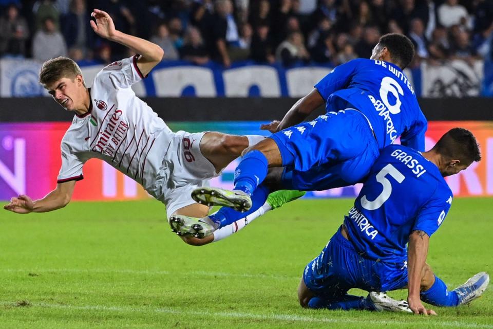 1 October 2022: AC Milan’s Charles De Ketelaere, left, collides with Empoli’s Koni de Winter and Alberto Grassi, right during their Serie A football match at the Carlo-Castellani stadium (AFP/Getty)