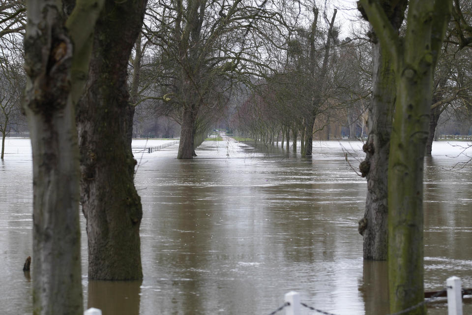 Trees in a park by the River Thames, in Datchet, England, is submerged in water, Monday, Feb. 10, 2014. The River Thames has burst its banks after reaching its highest level in years, flooding riverside towns upstream of London. Residents and British troops had piled up sandbags in a bid to protect properties from the latest bout of flooding to hit Britain. But the floods overwhelmed their defences Monday, leaving areas including the centre of the village of Datchet underwater. (AP Photo/Sang Tan)