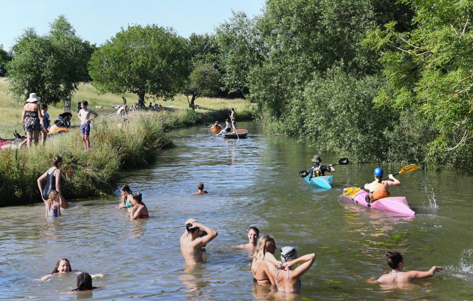 People play in the River Cam in Grantchester near Cambridge as Thursday could be the UK's hottest day of the year with scorching temperatures forecast to rise even further.