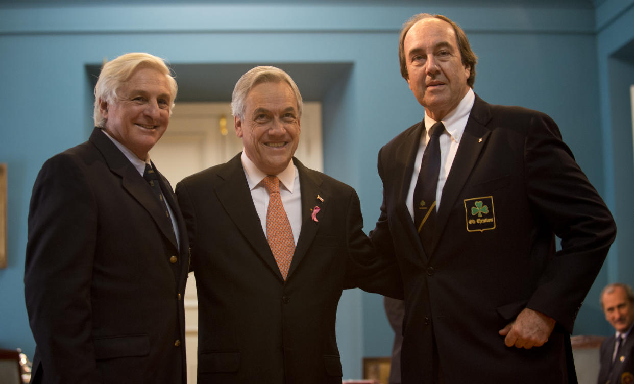 Chilean President Sebastian Pinera (C) poses with  Uruguayans Roberto Canessa (L) and Nando Parrado (R), two of the 16 survivors of an airplane crash in the Chilean Andes in 1972 and who remained lost in the mountains for 72 days, during the commemoration of the 40th anniversary of their tragedy, in Santiago  on October 12 , 2012.    AFP PHOTO/Martin BERNETTI        (Photo credit should read MARTIN BERNETTI/AFP/GettyImages)