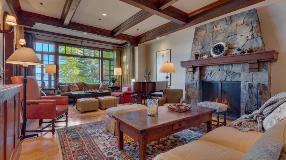 The living room, with wood-beamed ceilings and a grand stone fireplace - Credit: Photo-tecture