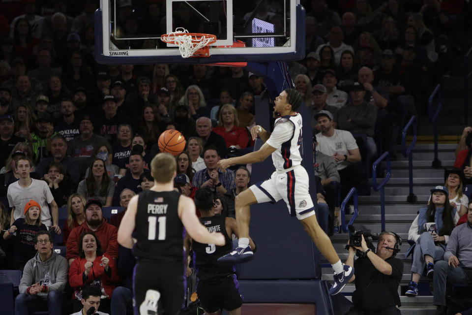 Gonzaga guard Rasir Bolton, right, comes down form a dunk during the first half of the team's NCAA college basketball game against Portland, Saturday, Jan. 14, 2023, in Spokane, Wash. (AP Photo/Young Kwak)