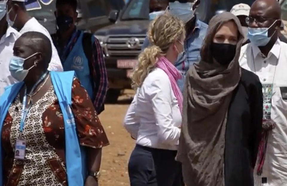 In this image taken from video, Special Envoy to the United Nations High Commissioner for Refugees Angelie Jolie, right, visits the Malian refugee camp in Goudebo, Burkina Faso, Sunday June 20, 2021, to mark World Refugee day on Sunday. Hollywood actress Angelina Jolie has visited war-weakened Burkina Faso to show solidarity with people who continue to welcome the displaced, despite grappling with their own insecurity, and said the world isn’t doing enough to help. (AP Photo)