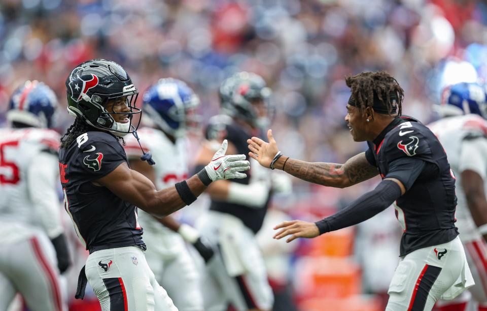 Aug 17, 2024; Houston, Texas, USA; Houston Texans wide receiver John Metchie III (8) celebrates with wide receiver Tank Dell (3) after a touchdown during the second quarter against the New York Giants at NRG Stadium. Mandatory Credit: Troy Taormina-USA TODAY Sports