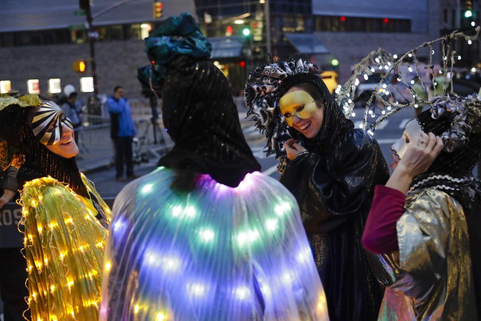 Revelers gather for the Greenwich Village Halloween Parade, Thursday, Oct. 31, 2019, in New York. (AP Photo/Frank Franklin II)