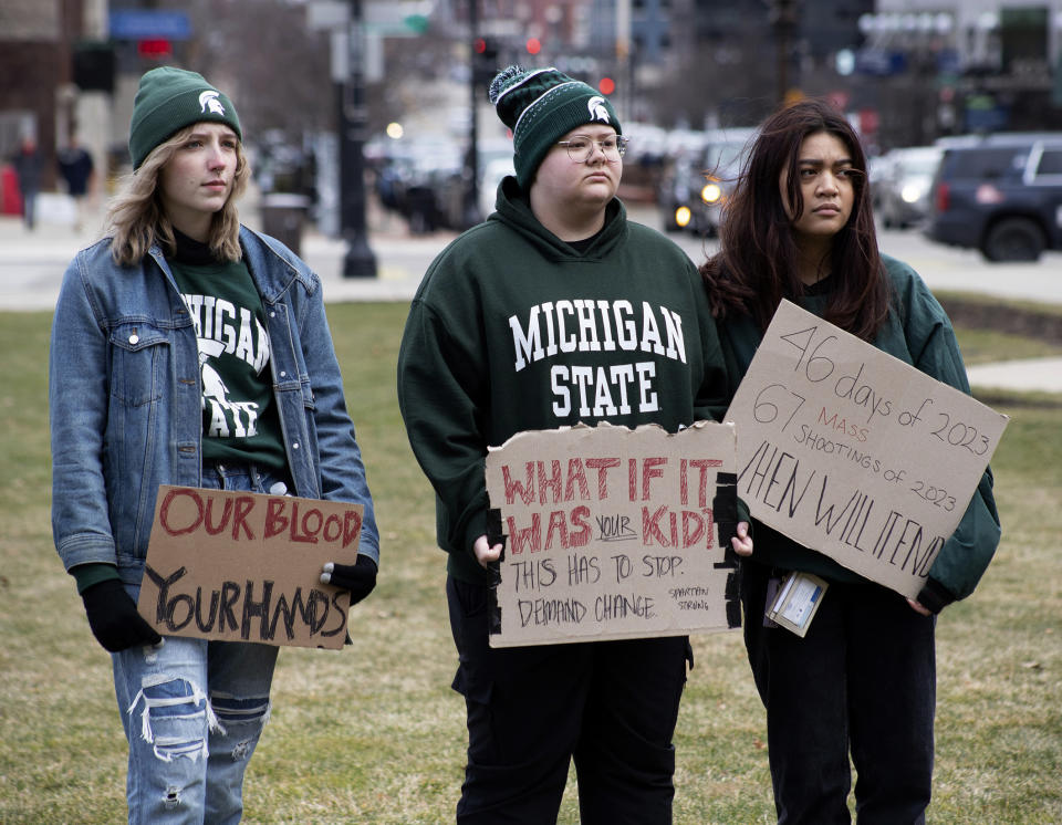 Demonstrators hold signs to protest gun violence at a student sit-in at the Michigan Capitol building following a mass shooting at Michigan State University earlier in the week, in Lansing, Mich., Wednesday, Feb. 15, 2023. (Brice Tucker/The Flint Journal via AP)