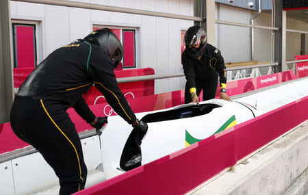 Bobsleigh - Pyeongchang 2018 Winter Olympics - Women's Training - Olympic Sliding Centre - Pyeongchang, South Korea - February 18, 2018 - Jazmine Fenlator-Victorian and Carrie Russell of Jamaica push their bobsleigh after their run. REUTERS/Edgar Su