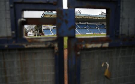Rugby Park Stadium, a 15,000 seat venue where Elton John once performed, is seen though a gate in Kilmarnock, Scotland March 25, 2014. REUTERS/Suzanne Plunkett