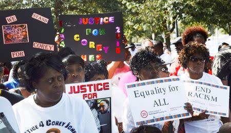 Protestors hold a peaceful rally in Palm Beach Gardens, Florida October 22, 2015. Corey Jones, a 31-year-old black drummer who was shot and killed by a plainclothes police officer after his car broke down on a highway exit ramp never fired the handgun he was carrying and was running away at one point, lawyers for the dead man's family said on October 22, 2015. REUTERS/Zachary Fagenson