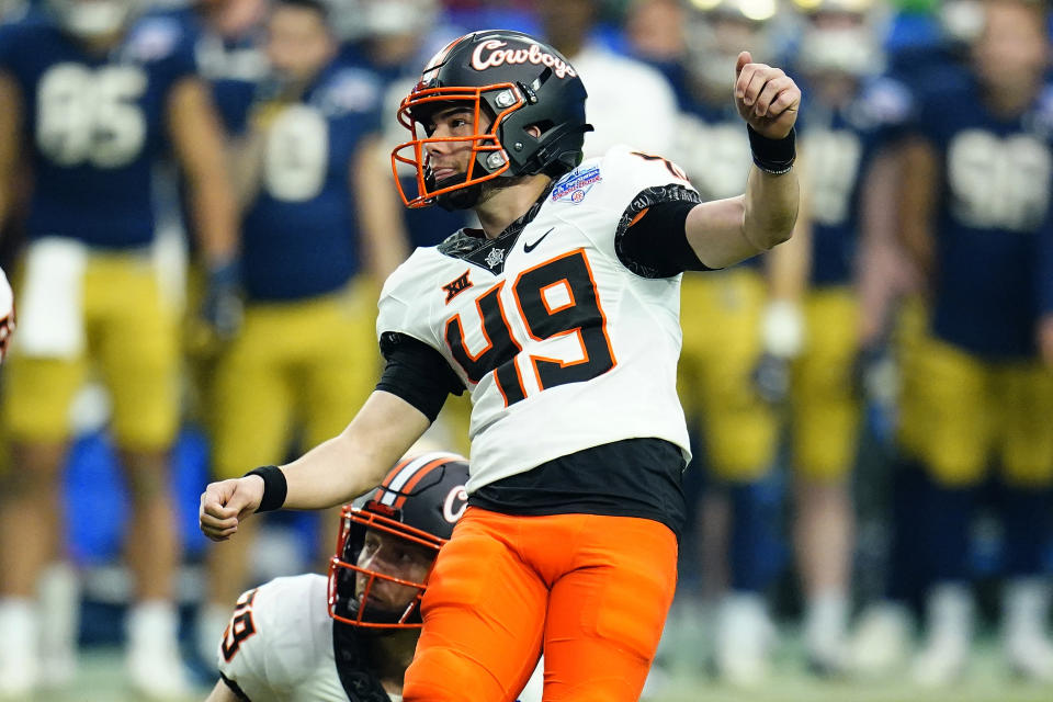 Oklahoma State place kicker Tanner Brown (49) watches his field goal split the uprights during the second half of the Fiesta Bowl NCAA college football game against Notre Dame, Saturday, Jan. 1, 2022, in Glendale, Ariz. (AP Photo/Ross D. Franklin)