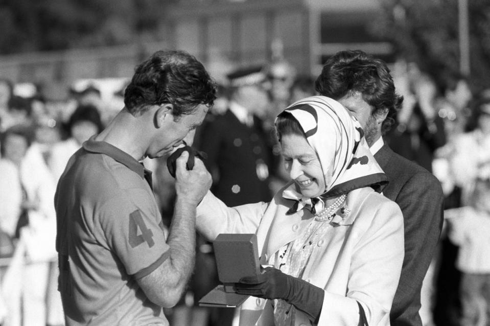 The Queen presents Prince Charles with the runners-up prize at the Silver Jubilee Cup  match at Guards Polo Club in 1988 (PA Archive)