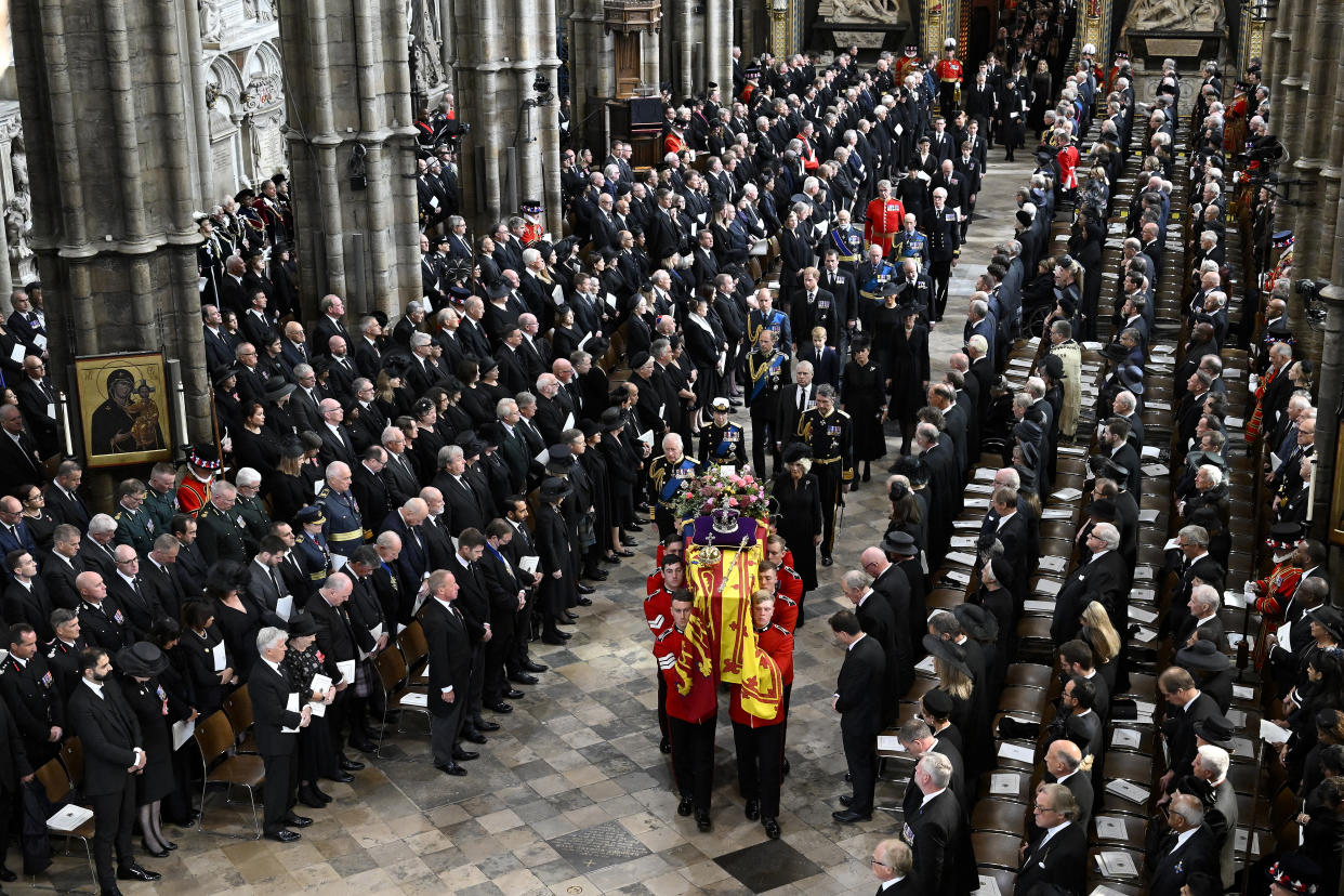 King Charles III and Queen Consort Camilla and other members of the royal family follow behind the coffin of Queen Elizabeth II with the imperial state crown resting on top of it as it departs Westminster Abbey on Monday.