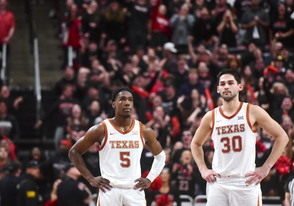 Texas players Marcus Carr and Brock Cunningham pause during the action of Monday night's loss to Texas Tech in Lubbock. It knocked the Longhorns from their perch atop the Big 12 standings into a jumped tie for first place.
