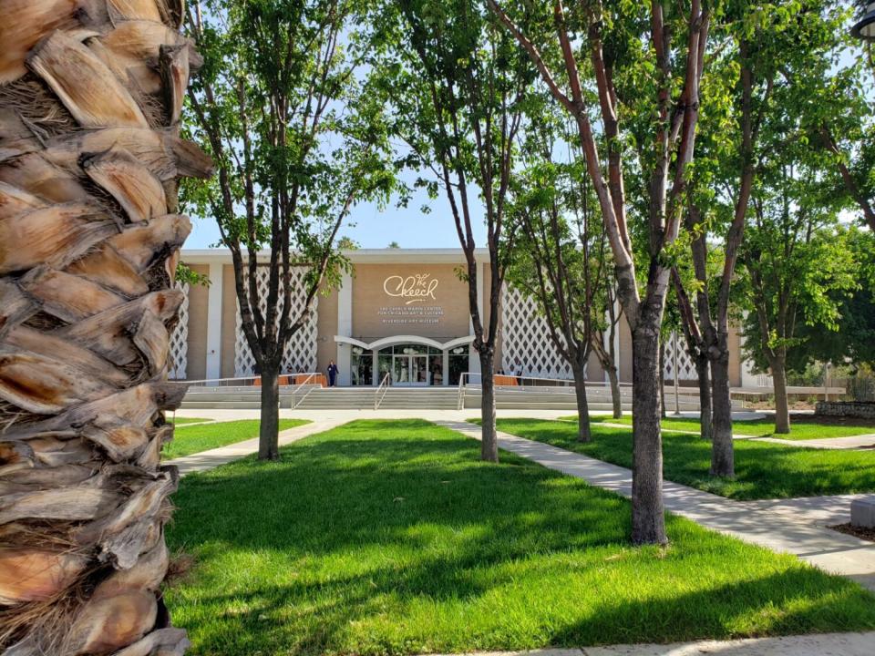 A building is seen through some trees.