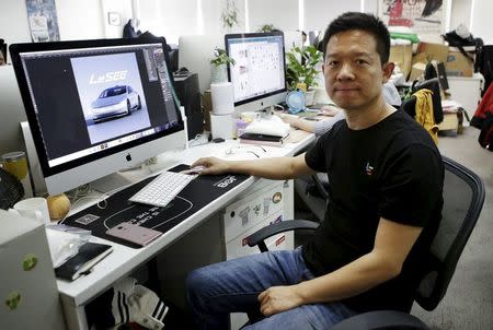 Jia Yueting, co-founder and head of Le Holdings Co Ltd, also known as LeEco and formerly as LeTV, poses for a photo next to a screen showing a picture of LeSEE concept car on a staff's seat after a Reuters interview at LeEco headquarters in Beijing, China, picture taken April 22, 2016. REUTERS/Jason Lee
