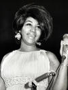 <p>Aretha Franklin wears a pleated empire dress with crystal earrings and glamourous hair at the Martin Luther King Benefit. (Photo by Getty Images) </p>