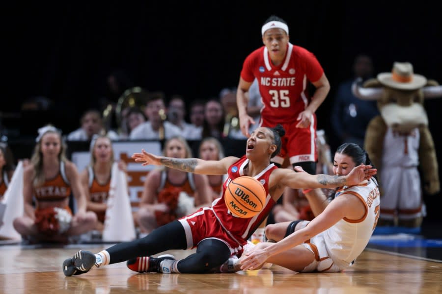 North Carolina State guard Aziaha James, left, and Texas guard Shaylee Gonzales, right, go for the ball during the first half of an Elite Eight college basketball game in the women’s NCAA Tournament, Sunday, March 31, 2024, in Portland, Ore. (AP Photo/Howard Lao)