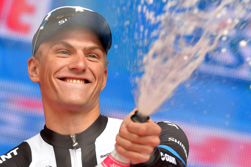 Germany's Marcel Kittel sprays sparkling wine as he celebrates on the podium after winning the 218-kilometer (135-mile) second stage of the Giro d'Italia, Tour of Italy cycling race, from Belfast to Belfast, Northern Ireland, Saturday May 10, 2014. (AP Photo/Giuan Mattia D'Alberto)